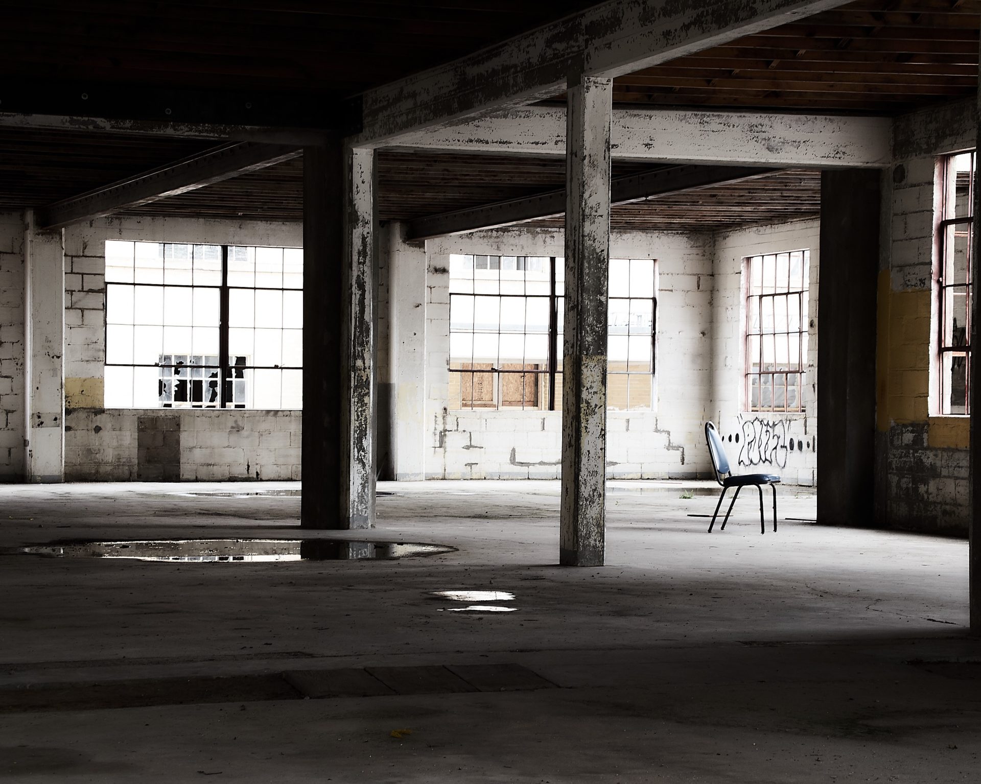 empty industrial building interior with single blue chair located at building 50 of the grand traverse commons in traverse city Michigan