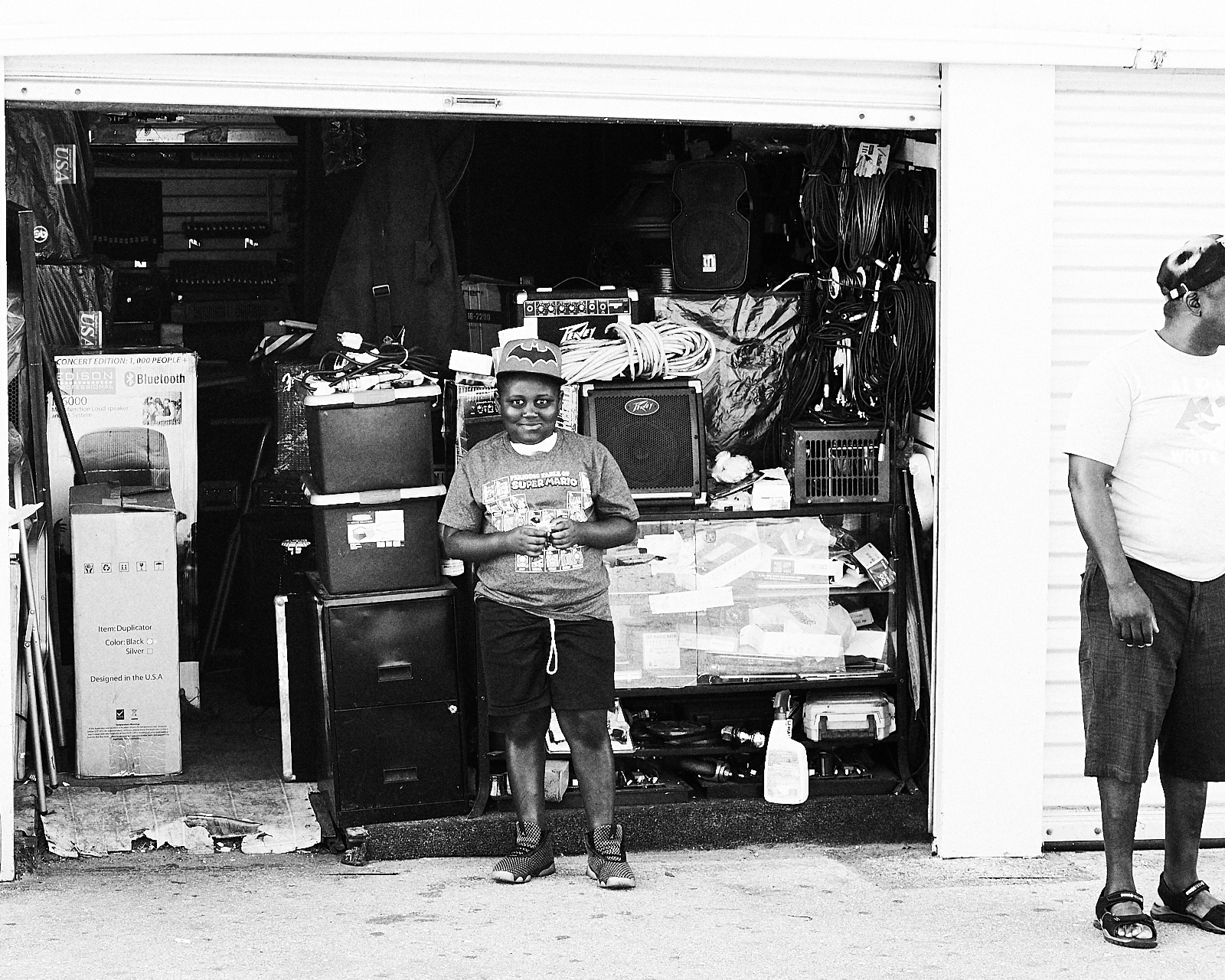 smiling boy standing in front of storage unit full of items in Fort Lauderdale Florida