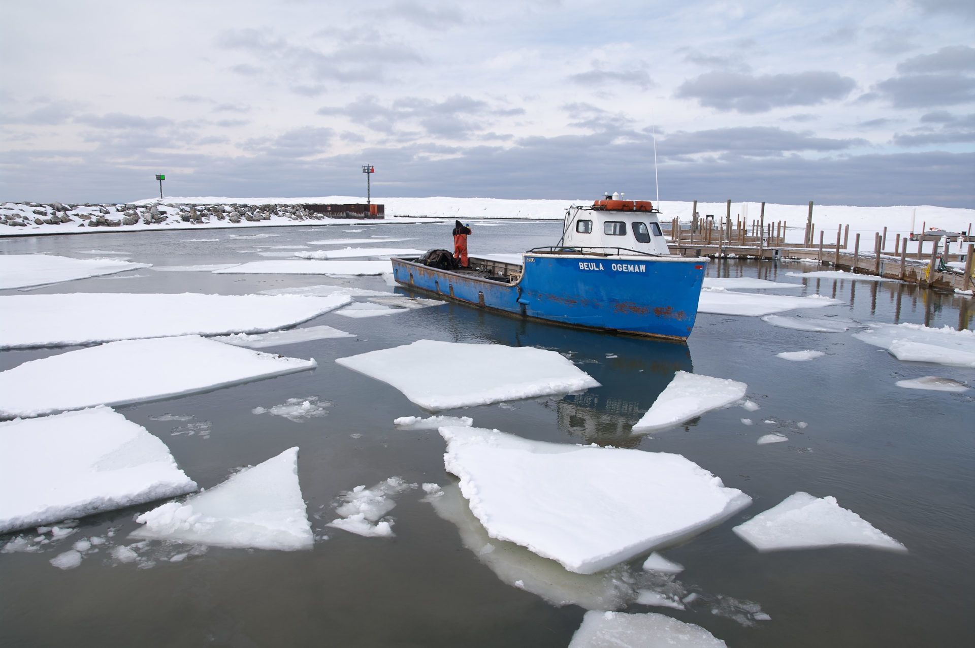 fishing tub breaking harbor ice in Leland Michigan