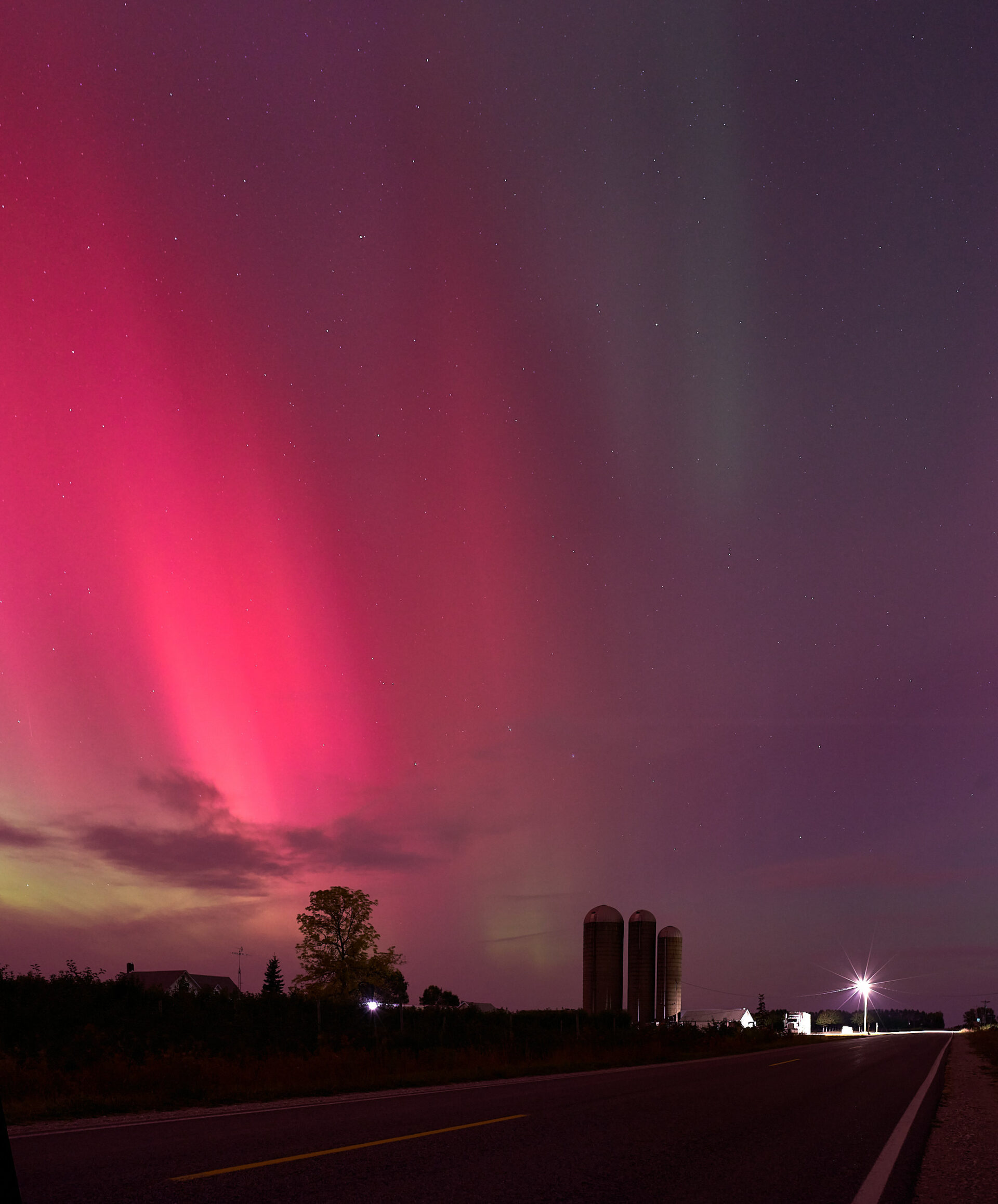 Northern Lights brightly showing greens, pinks, and purple in the skies above Leelanau County